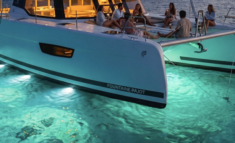 Tender alongside a yacht after dark